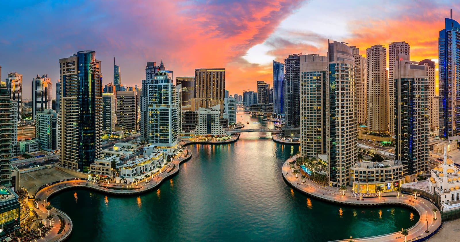 Dubai Marina at sunset — towers and waterfront promenades around the water